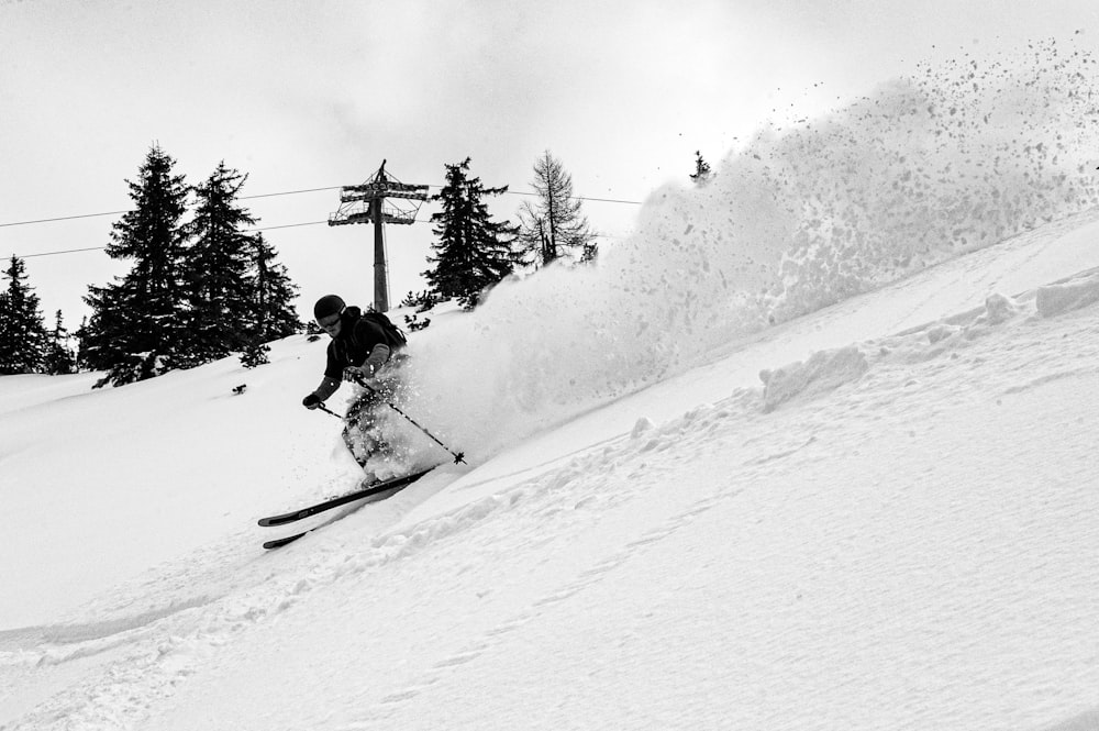 person riding ski blades on snow covered mountain during daytime