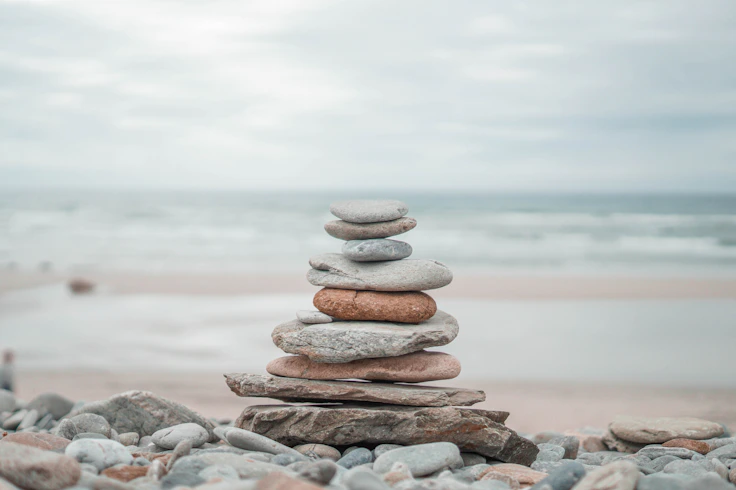 stack of stones on beach shore during daytime