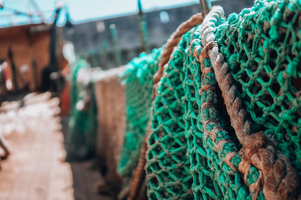 green and red rope on brown wooden fence during daytime