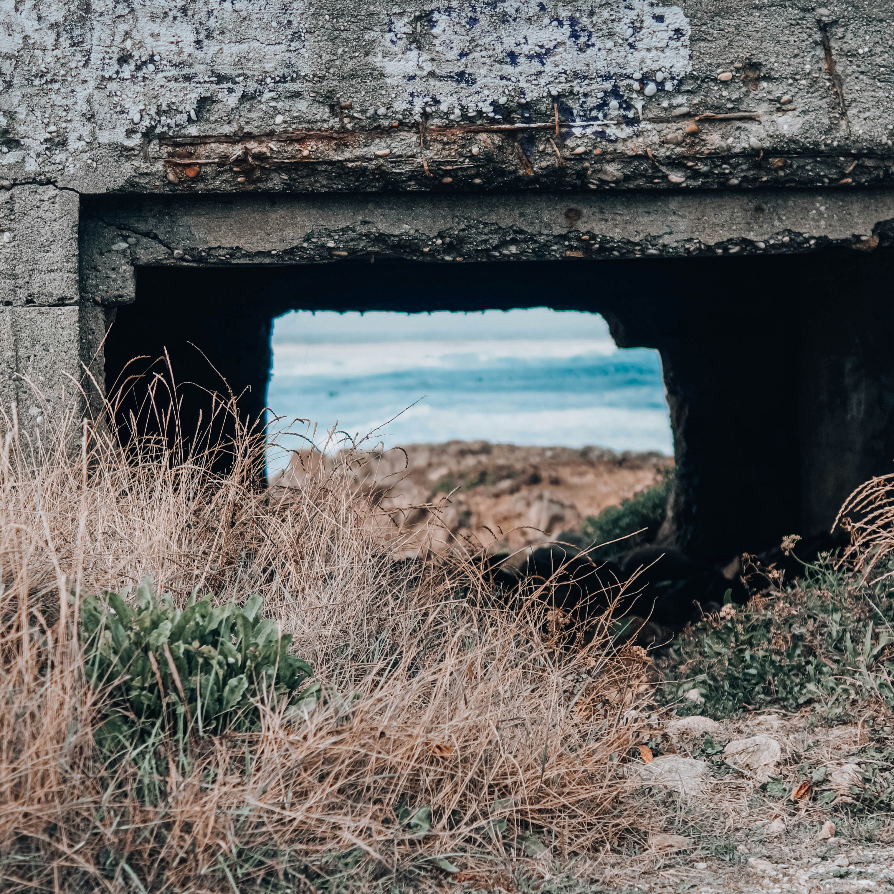 gray concrete wall near body of water during daytime