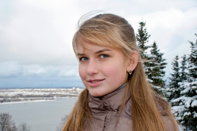 girl in gray jacket smiling enigmatic teams background