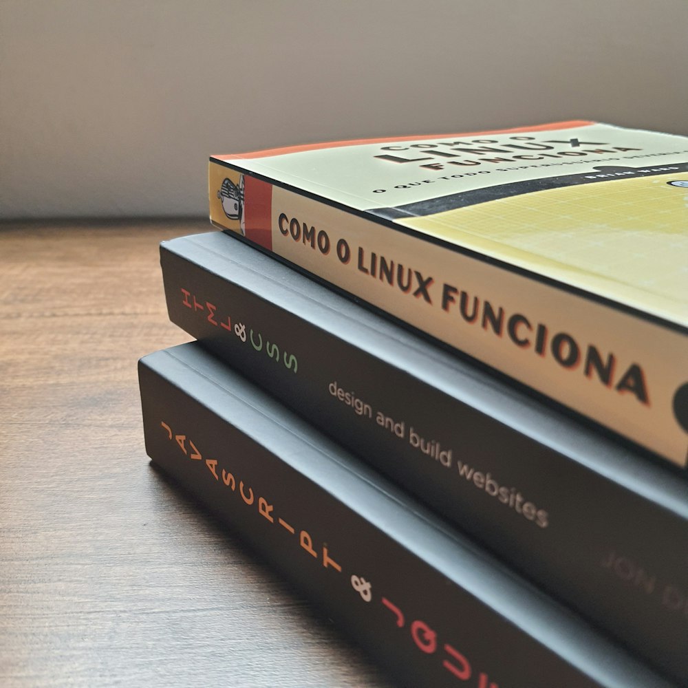 red and black books on brown wooden table