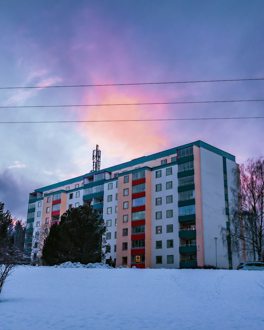 white and brown concrete building under white clouds during daytime