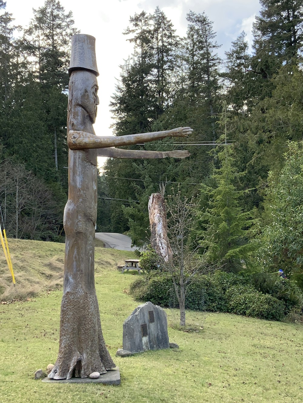 brown wooden cross on green grass field