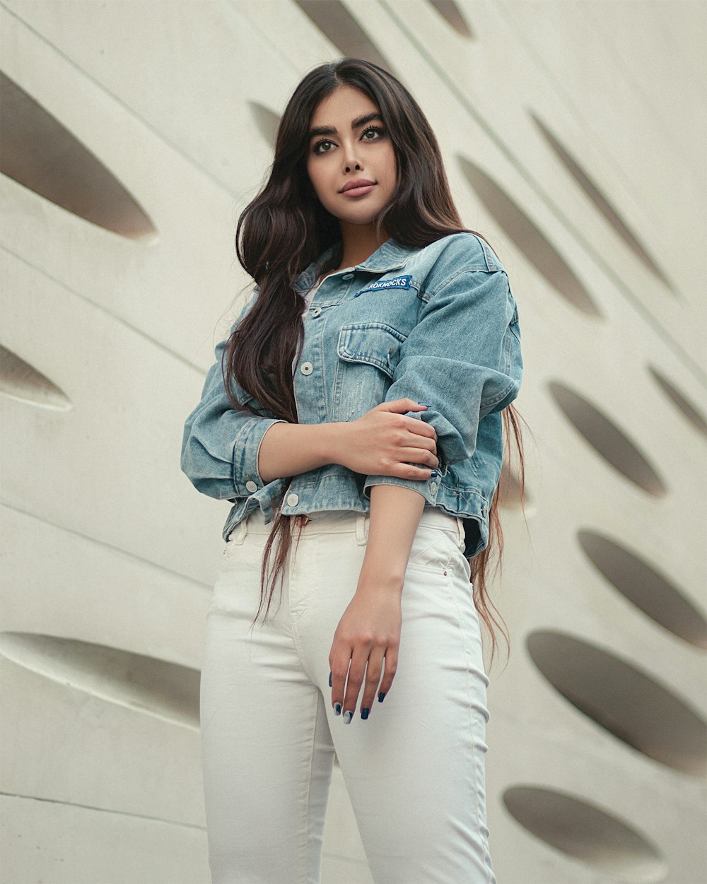 woman in blue denim jacket and white pants