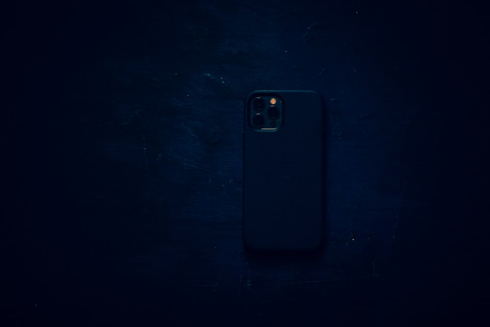 black smartphone case on black textile
