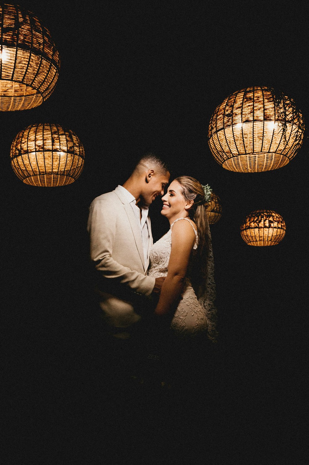 man and woman kissing beside brown wicker lantern