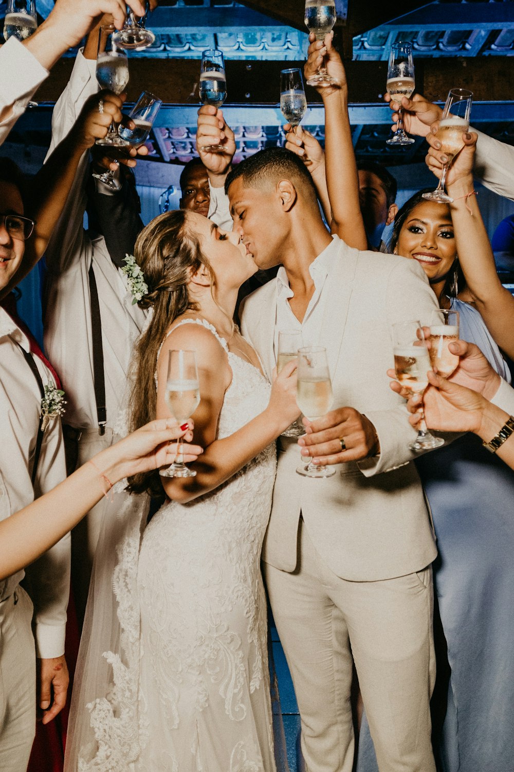 man in white suit holding woman in white dress