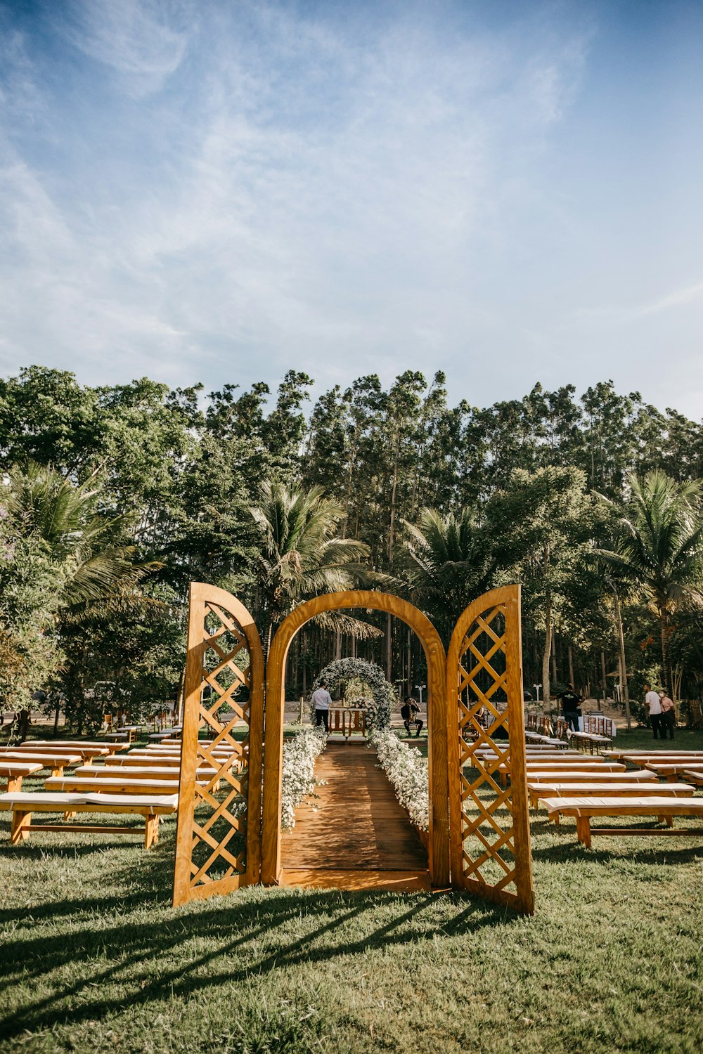 brown wooden bridge over river surrounded by green trees during daytime