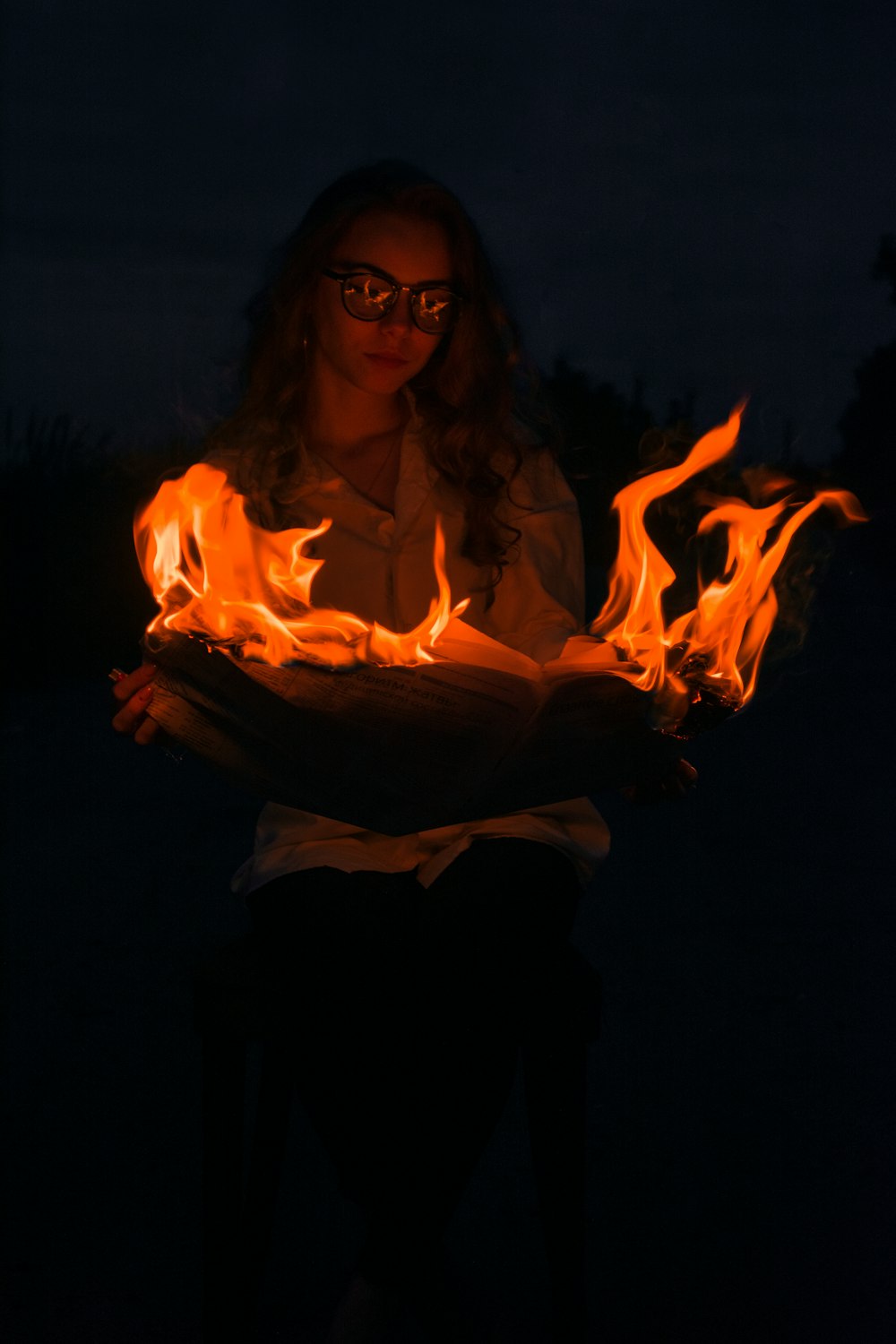 woman in black dress holding fire