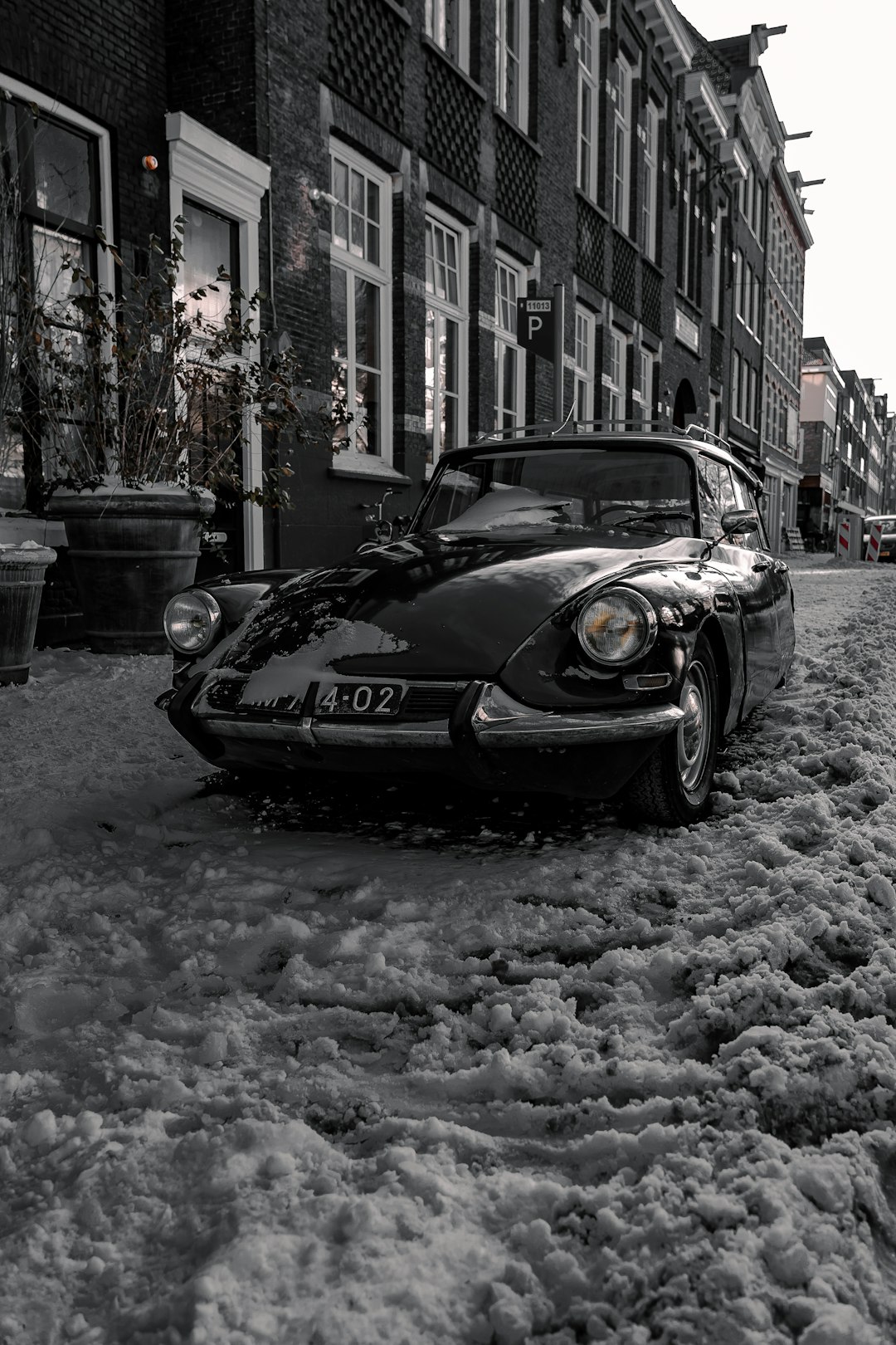 black porsche 911 parked on snow covered road