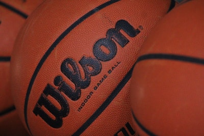 Close-up of several basketballs with visible brand text 'Wilson' and textured surface.