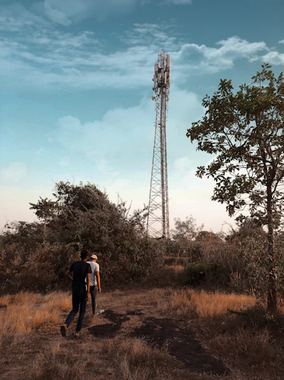 Two people communicating with Motorola walkie-talkies outdoors at dusk
