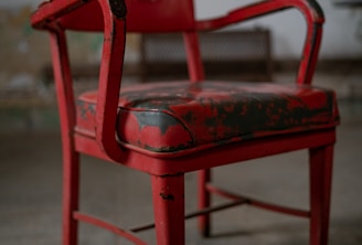 red plastic armchair on gray concrete floor