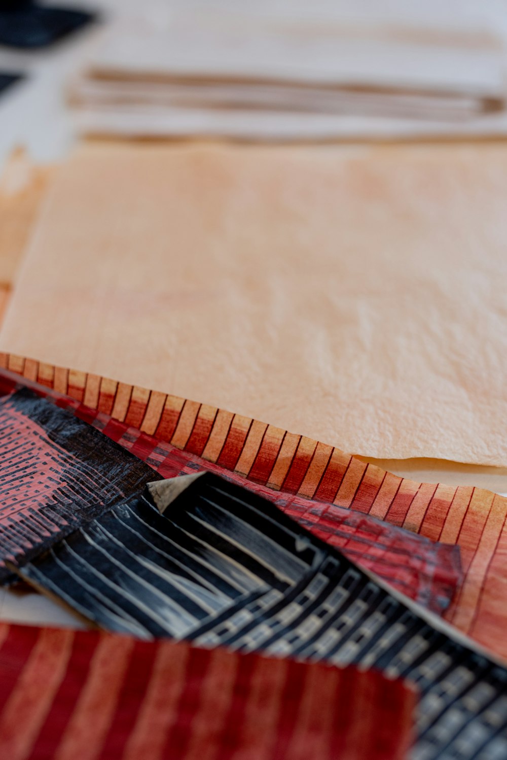 red and black textile on brown wooden table