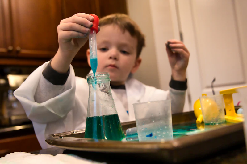 Children wearing safety goggles running a hands-on science experiment