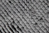 Close-up of the soft quilted mattress surface showing intricate fabric texture and stitching.