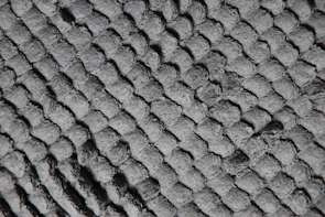 Close-up of the soft quilted mattress surface showing intricate fabric texture and stitching.