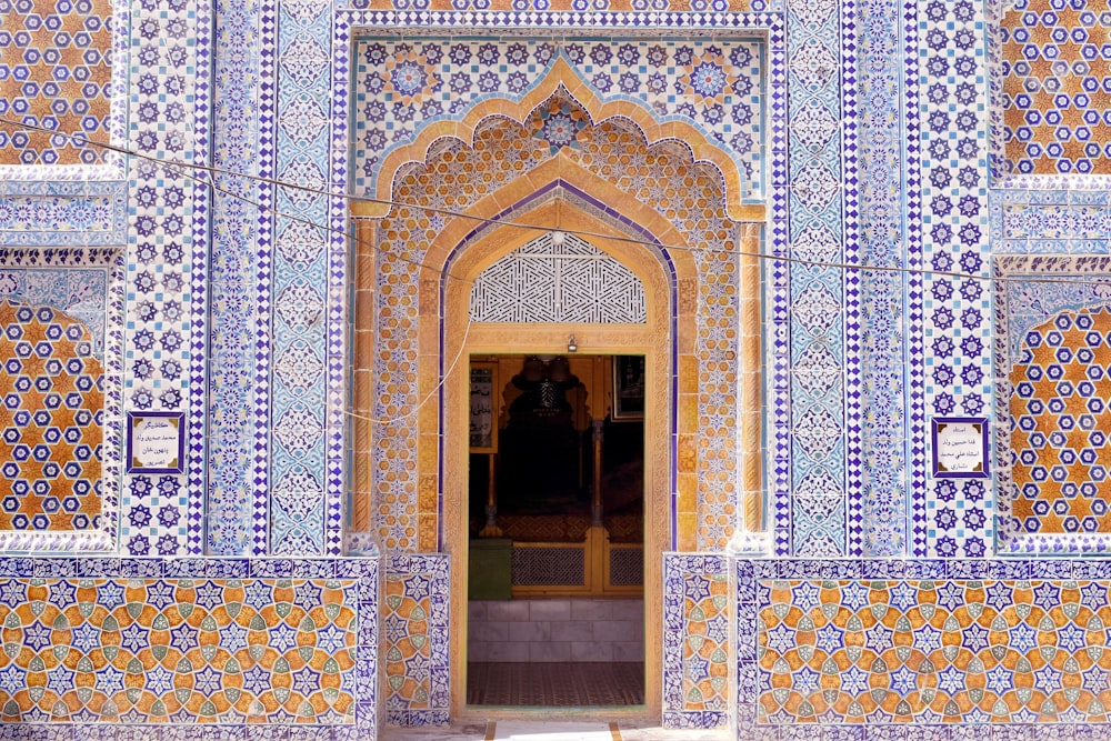 brown wooden door on blue and white floral wall