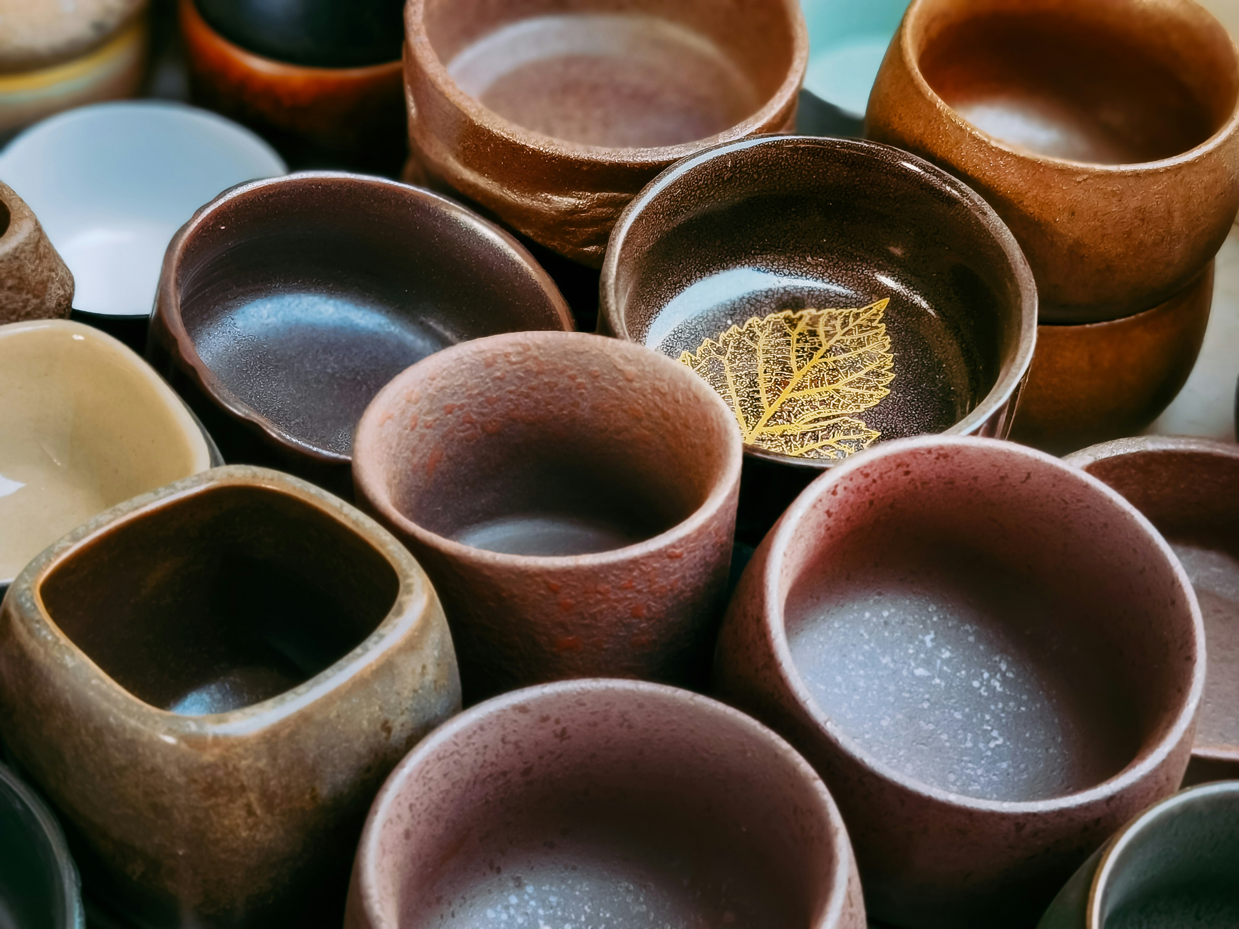 brown clay pot on orange plastic container