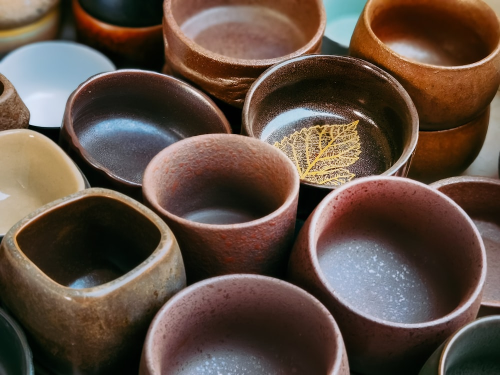 brown clay pot on orange plastic container