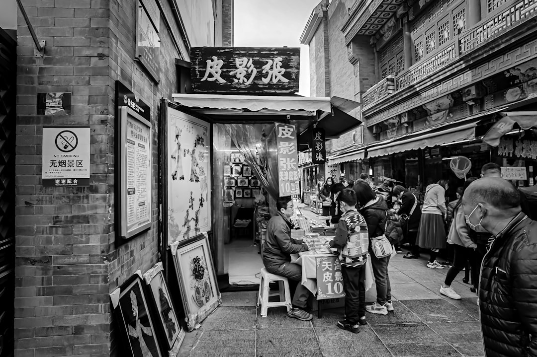 grayscale photo of people walking on street