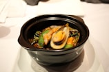 A vibrant display of mussels served with a rich Mediterranean sauce.