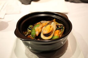A vibrant display of mussels served with a rich Mediterranean sauce.
