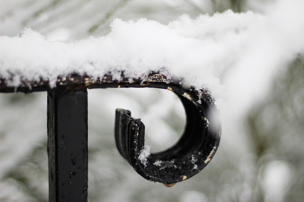 black metal handle bar covered with snow