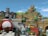 A vibrant and playful theme park scene with structures resembling blocks, coins, and characters from a popular video game franchise. The area features a castle with menacing stone statues, tiered earthwork adorned with cartoonish elements like question blocks and smiling clouds. Various colorful pipes, oversized mushrooms, and playful characters such as piranha plants are scattered throughout. Visitors are walking around, enjoying the themed environment.
