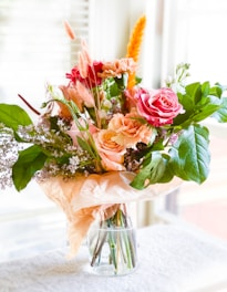 pink roses in clear glass vase