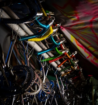 A variety of colorful motorcycle handle grips displayed on hooks.