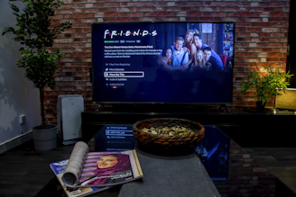 black flat screen tv turned on near brown brick wall