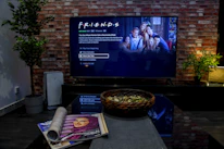 black flat screen tv turned on near brown brick wall