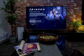 black flat screen tv turned on near brown brick wall