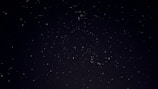 A starry night sky filled with floating crypto symbols and whimsical space creatures.