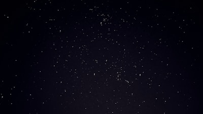 A serene cosmic sky with golden constellations forming ancient Vedic symbols.