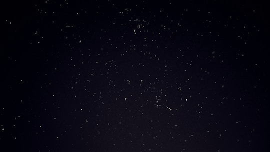 A serene night sky filled with bright stars and zodiac constellations.