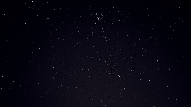 A serene cosmic landscape with stars and planets.