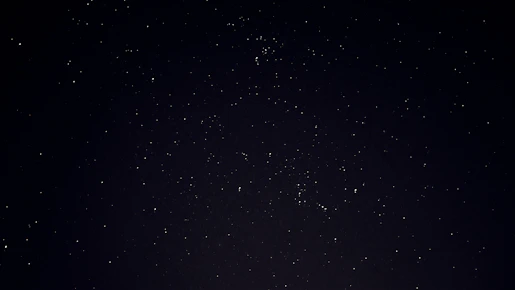 A serene night sky filled with glowing zodiac constellations and golden nav grah symbols.