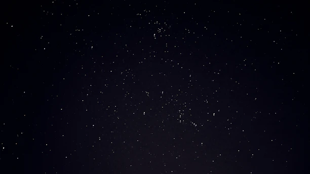 A serene cosmic night sky with stars forming subtle astrological symbols.