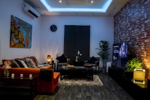 A cozy living room featuring warm orange walls and tamota red accents with modern furniture.