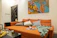 A cozy living room featuring a sleek, vacuum-sealed couch from popforma with soft orange accents.