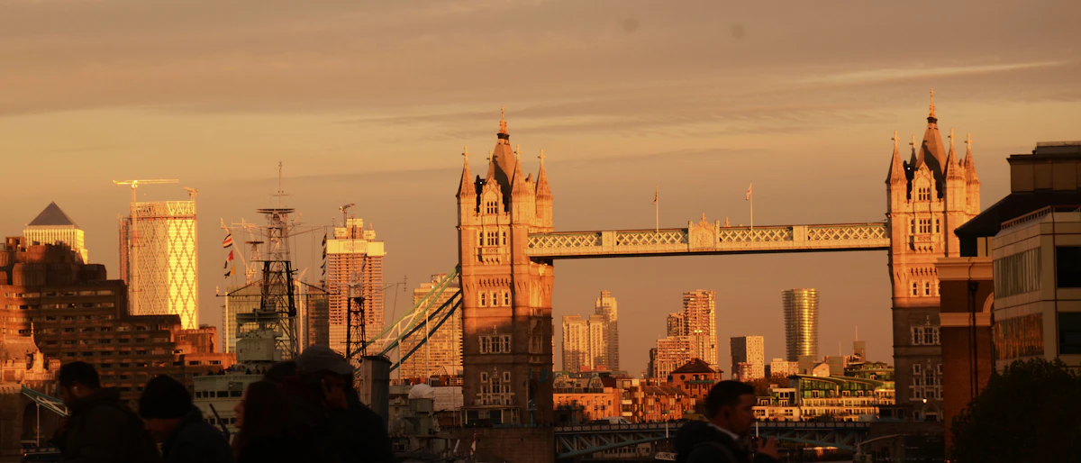 London cityscape with Tower Bridge and Thames River reflecting golden sunset