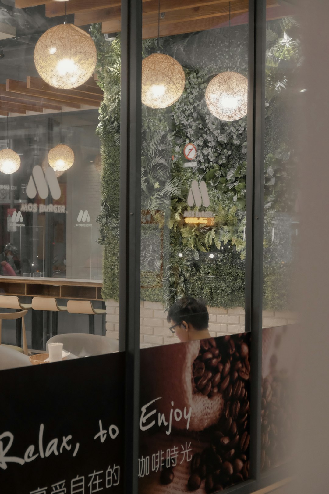 boy in red and white plaid dress shirt standing beside glass window