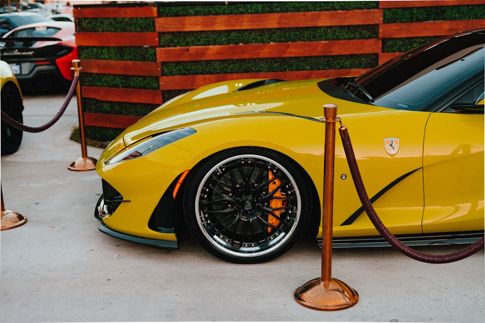 yellow ferrari 458 italia parked near brick wall