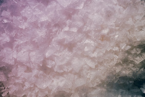 Shimmering lithium crystals reflecting light in a lab setting.