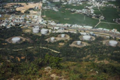 An aerial view of a large fuel storage facility surrounded by green landscape, highlighting environmental care.
