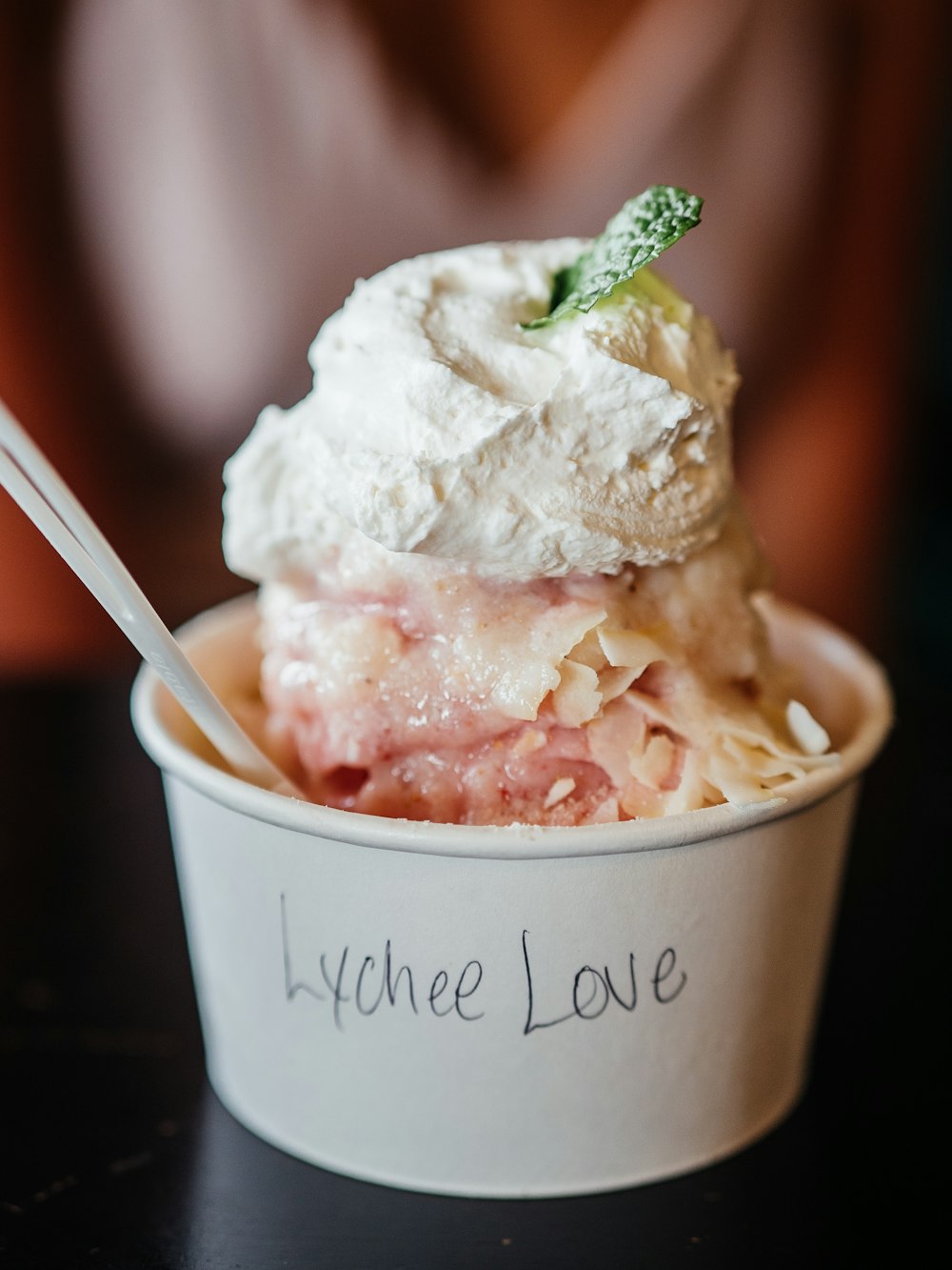 ice cream in white cup with stainless steel spoon