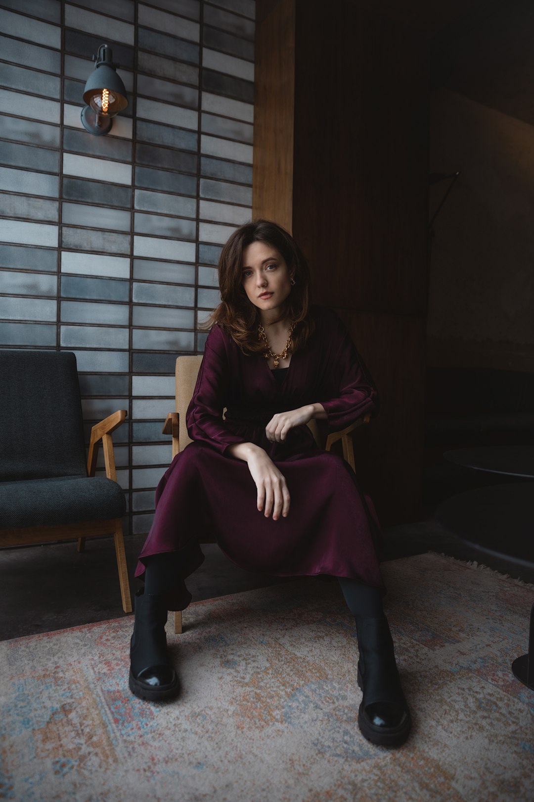 woman in red long sleeve dress sitting on brown sofa chair